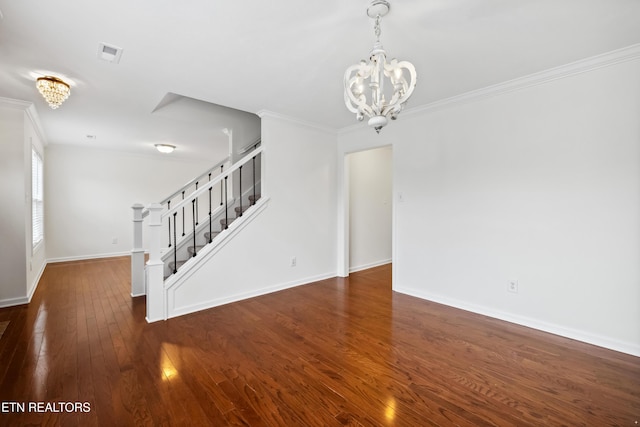 unfurnished living room featuring a notable chandelier, ornamental molding, and dark wood-type flooring