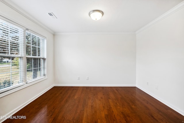 empty room featuring crown molding and hardwood / wood-style flooring