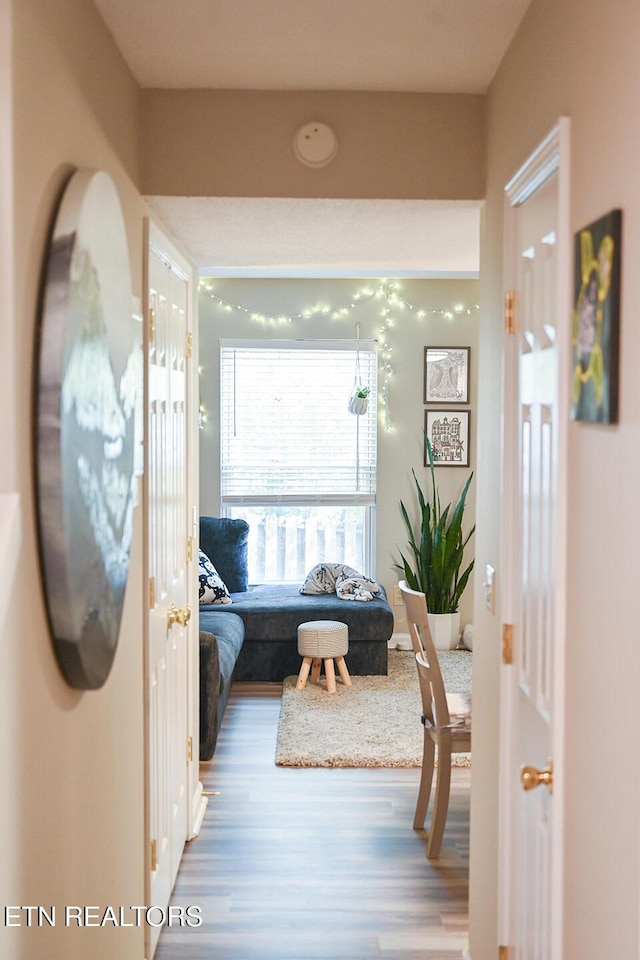 corridor with hardwood / wood-style floors