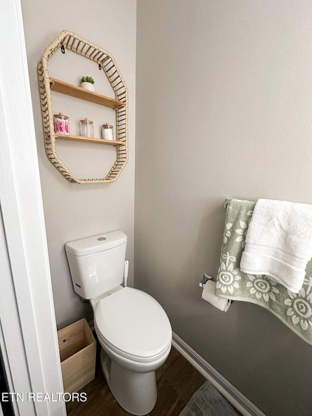 bathroom with toilet and hardwood / wood-style flooring