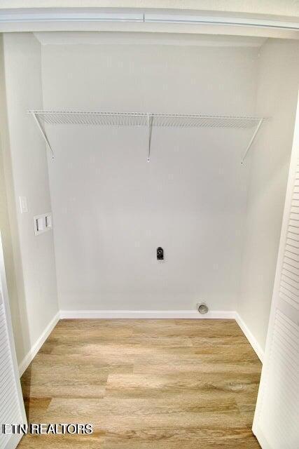 clothes washing area with electric dryer hookup and hardwood / wood-style floors