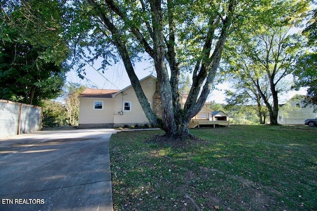 view of side of home featuring a lawn