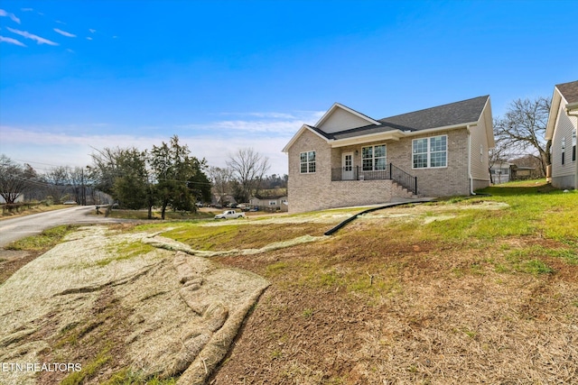 view of side of home with a lawn