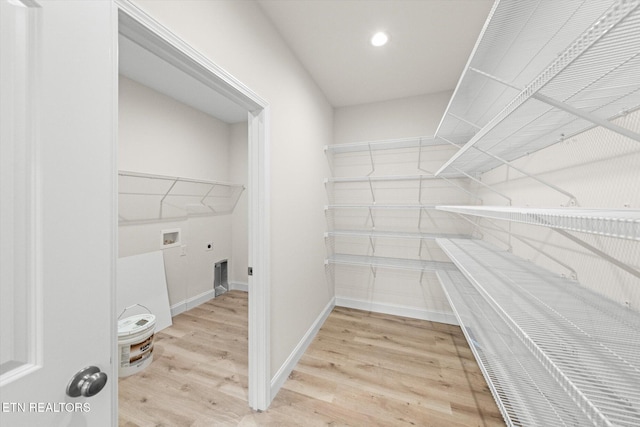 spacious closet featuring light hardwood / wood-style floors