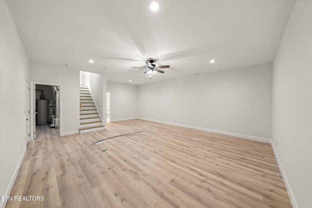 interior space with gas water heater, light hardwood / wood-style flooring, and ceiling fan