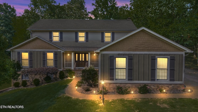 view of front facade featuring a lawn and a porch