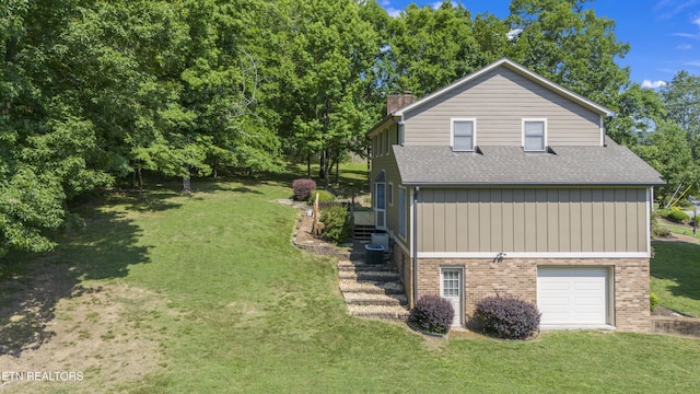 view of property exterior featuring a yard and a garage