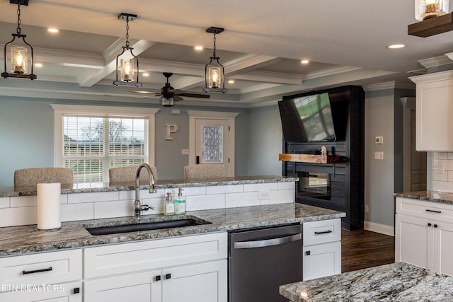 kitchen with stainless steel dishwasher, sink, beamed ceiling, white cabinets, and dark hardwood / wood-style floors