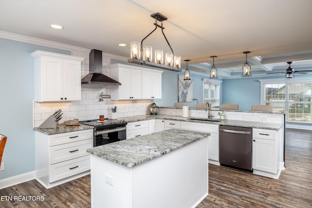 kitchen with pendant lighting, wall chimney range hood, sink, appliances with stainless steel finishes, and kitchen peninsula