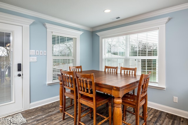 dining area with dark wood-type flooring and ornamental molding