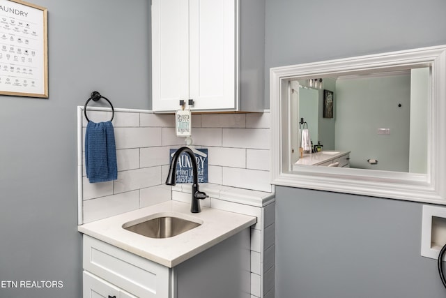 bathroom with vanity and backsplash