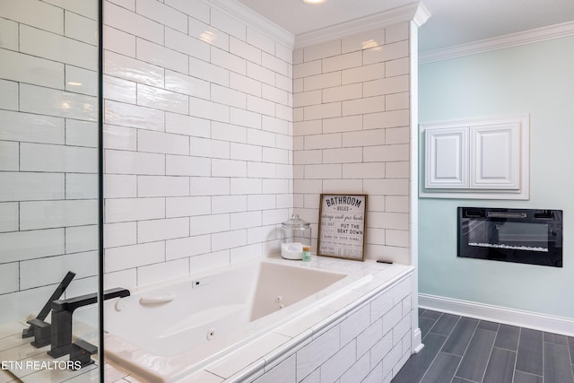 bathroom featuring crown molding and tiled tub