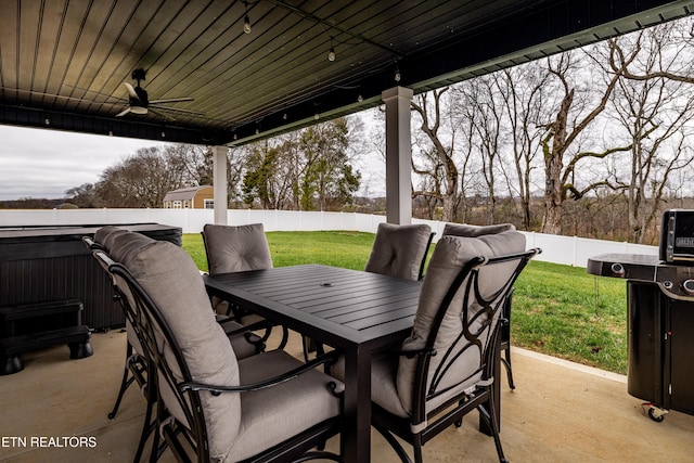 view of patio with ceiling fan and a hot tub