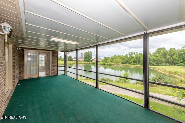 unfurnished sunroom with a water view