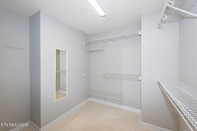 walk in closet featuring light floors