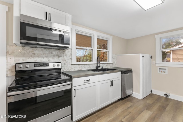 kitchen featuring white cabinetry, a healthy amount of sunlight, and appliances with stainless steel finishes