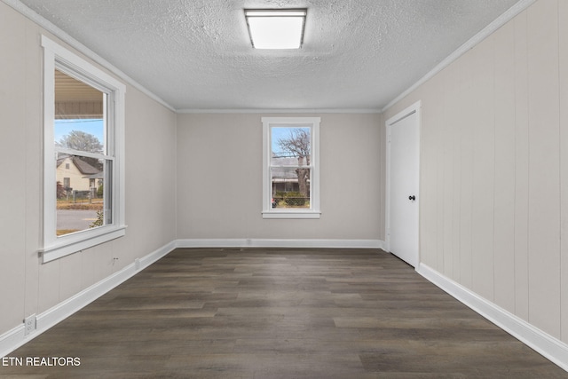 unfurnished room featuring a textured ceiling, dark hardwood / wood-style floors, and ornamental molding