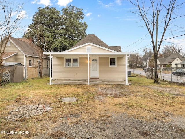 bungalow-style home featuring a front yard