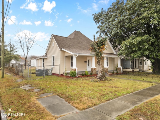 view of front facade with cooling unit, a front lawn, and a porch