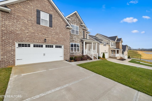 view of front of house with a garage and a front lawn