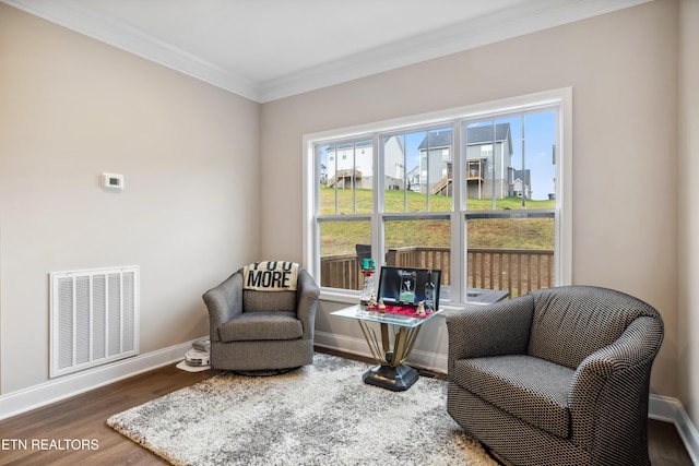 living area featuring crown molding and dark wood-type flooring