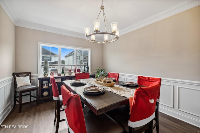 dining area with ornamental molding, dark wood-type flooring, and a notable chandelier