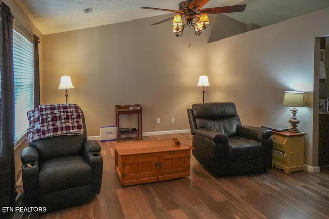 living area with dark hardwood / wood-style floors, vaulted ceiling, and ceiling fan