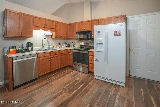 kitchen with stainless steel appliances, high vaulted ceiling, dark hardwood / wood-style floors, and sink