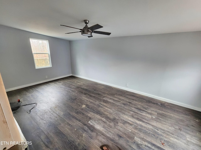 spare room with ceiling fan and dark hardwood / wood-style flooring