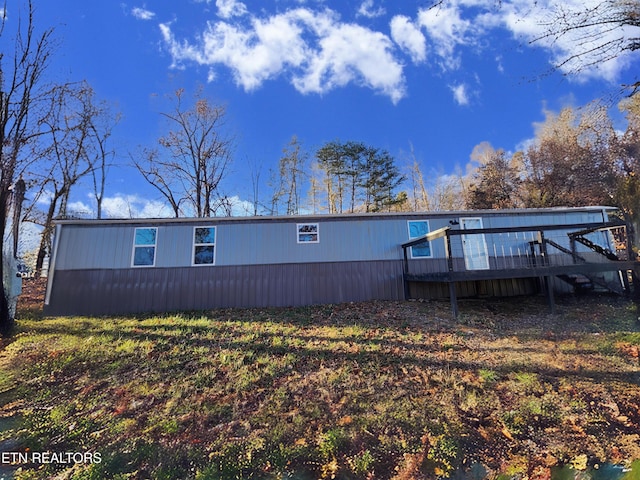 back of property featuring a deck