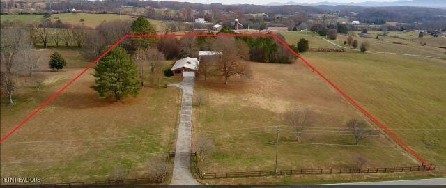 birds eye view of property featuring a rural view