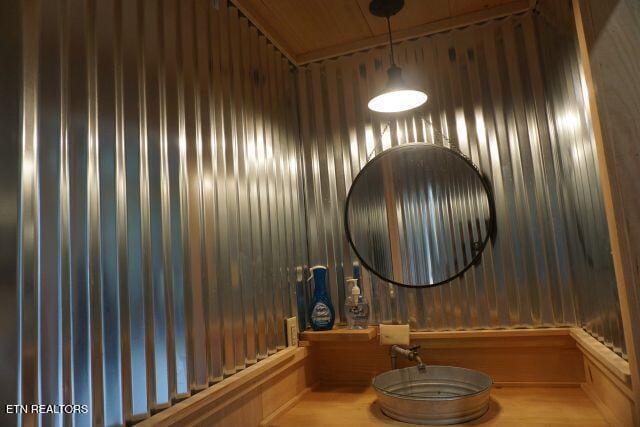 bathroom with wood ceiling and wood walls