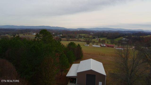 birds eye view of property featuring a mountain view and a rural view