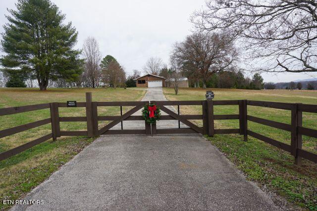 view of gate featuring a yard