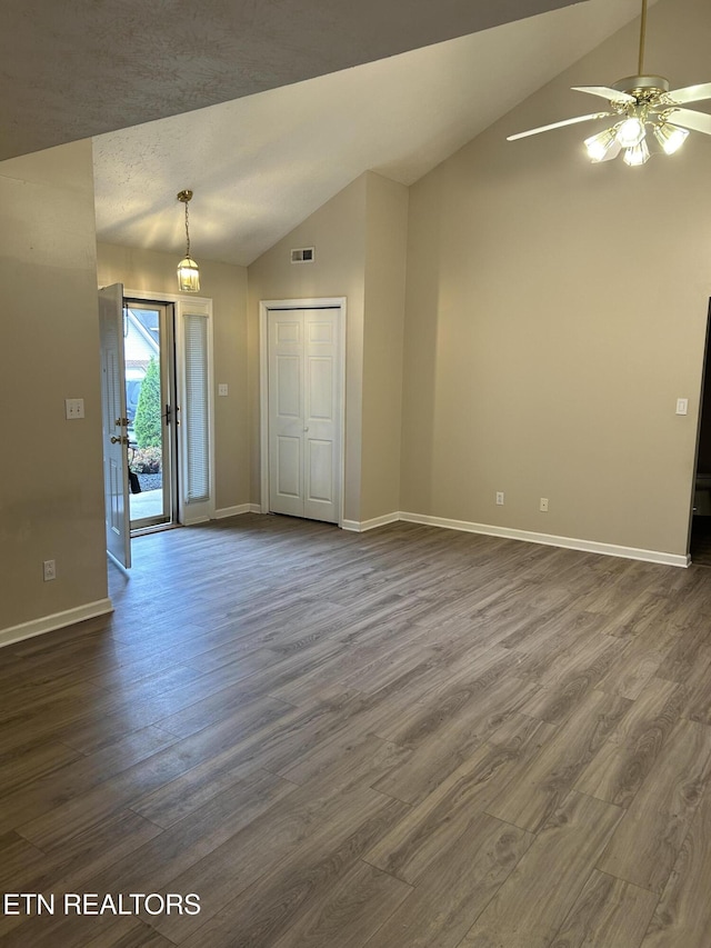 unfurnished room with vaulted ceiling, dark wood-type flooring, and ceiling fan