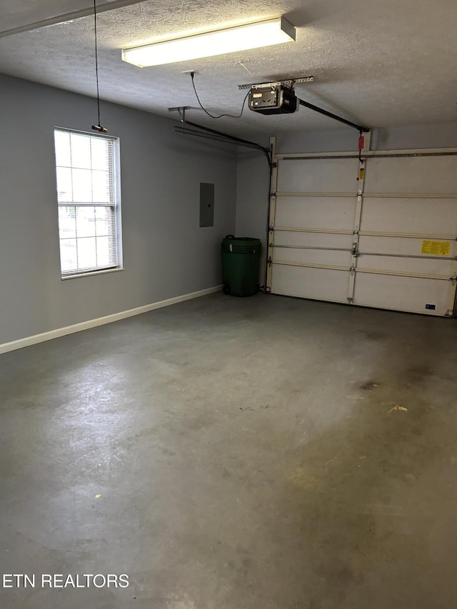 garage with a garage door opener and electric panel