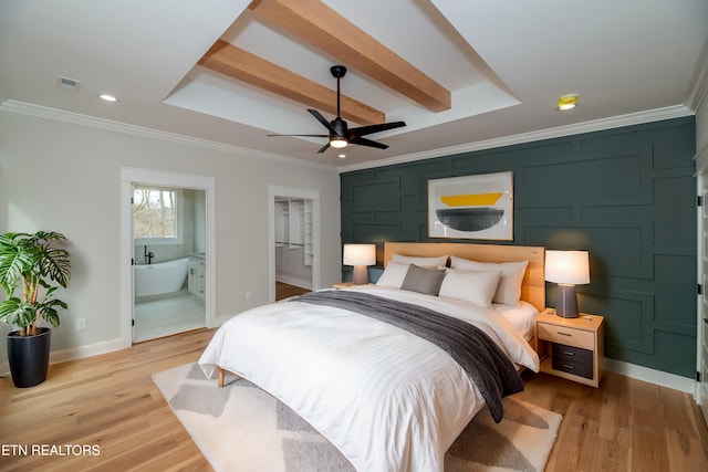 bedroom with a raised ceiling, ornamental molding, visible vents, and light wood-type flooring