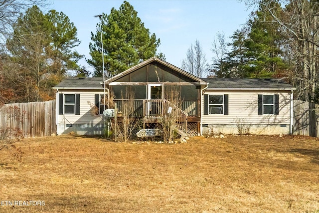 rear view of property featuring a sunroom