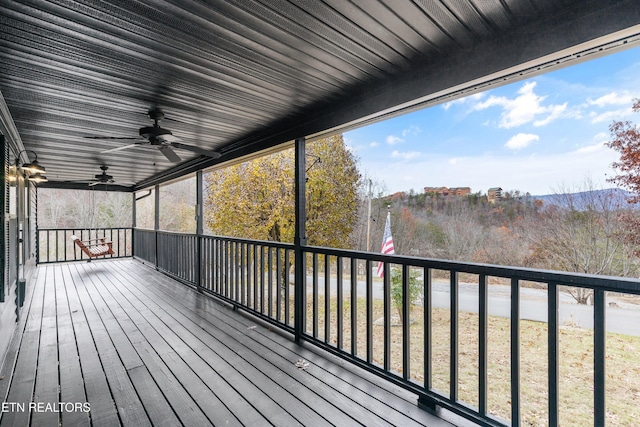 wooden terrace featuring ceiling fan