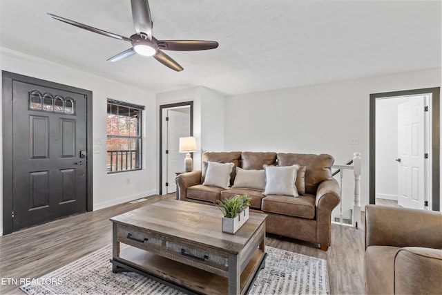 living room with ceiling fan and light wood-type flooring