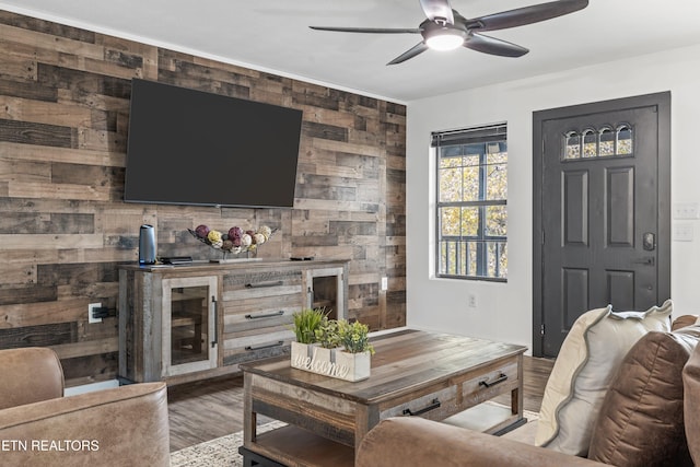 living room featuring ceiling fan and hardwood / wood-style flooring