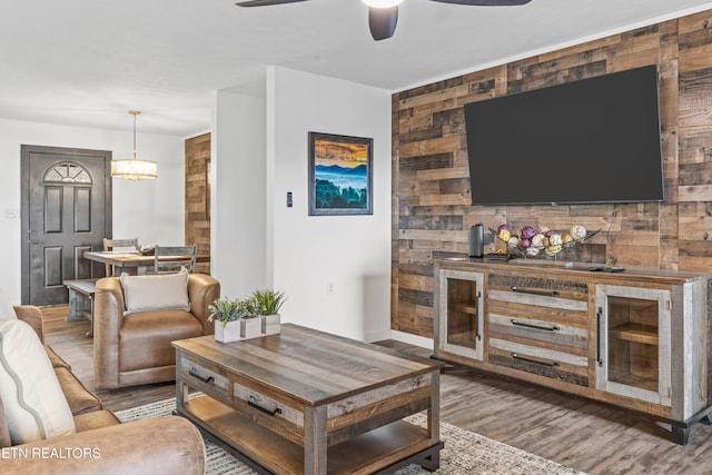 living room featuring wooden walls and wood-type flooring