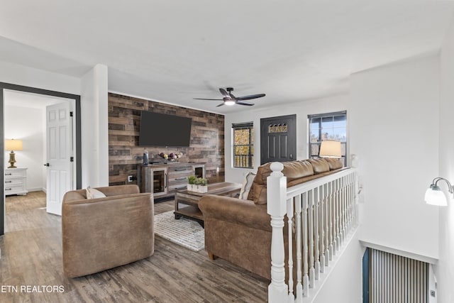 living room with wood-type flooring and ceiling fan