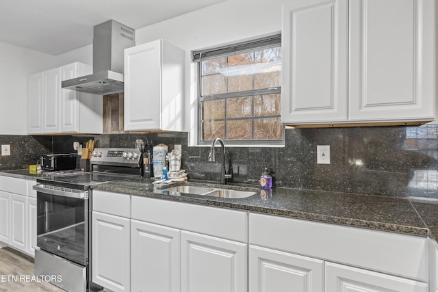 kitchen with wall chimney exhaust hood, white cabinetry, stainless steel electric range oven, and sink