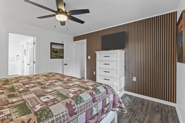 bedroom featuring ceiling fan, ensuite bathroom, and dark hardwood / wood-style floors