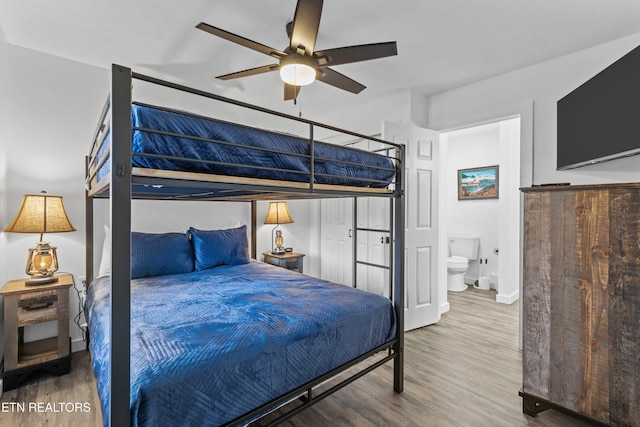 bedroom featuring wood-type flooring, ensuite bathroom, and ceiling fan