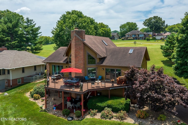 back of property featuring a patio, a deck, and a lawn