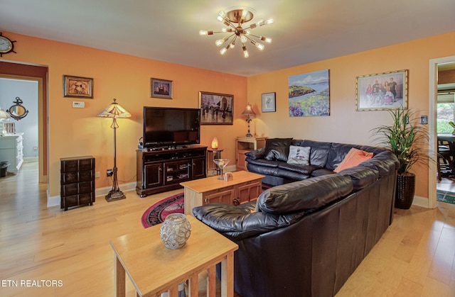 living room featuring a notable chandelier and light hardwood / wood-style floors