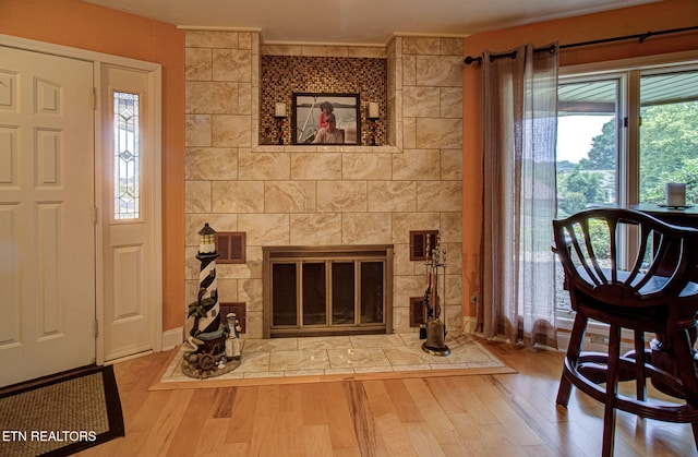 interior space featuring hardwood / wood-style floors and a tile fireplace