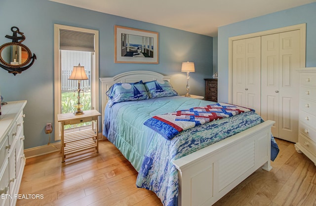 bedroom with light wood-type flooring and a closet